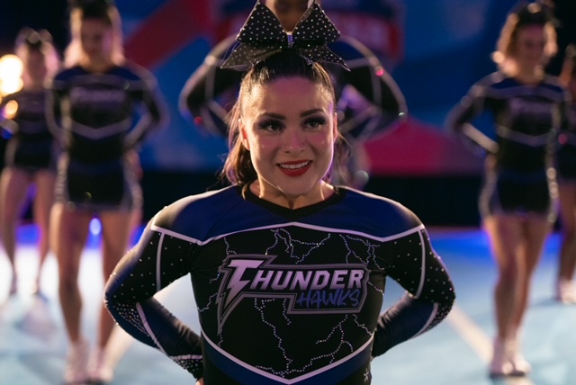 Devery Jacobs in a black and purple gymnast uniform looking nervous.